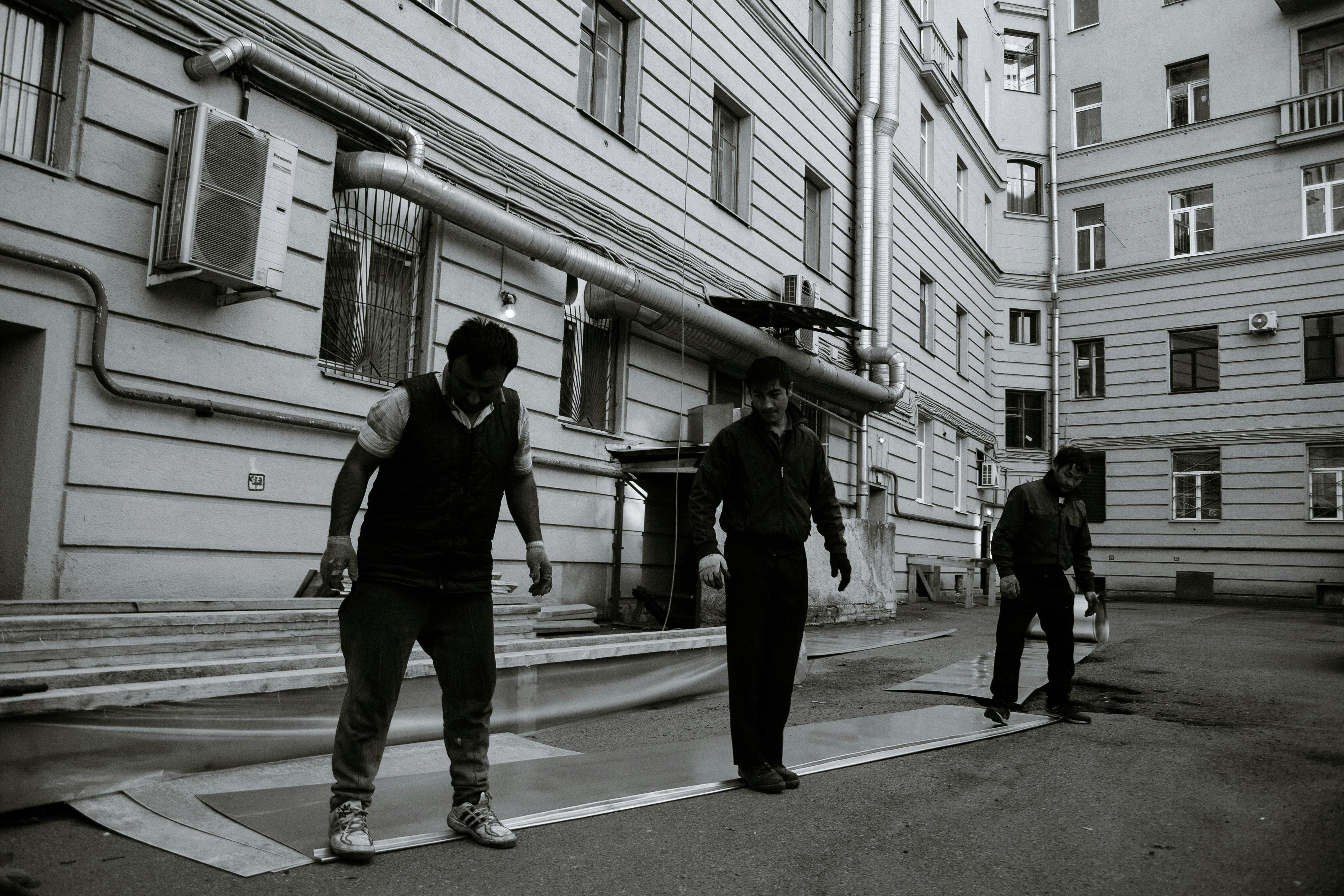 Man Scaling the Roof as He Inspects