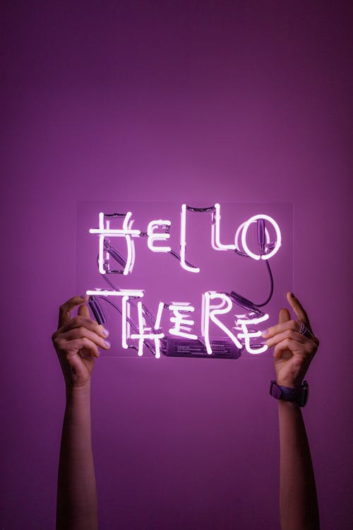 Free Person Holding A Neon Sign Stock Photo