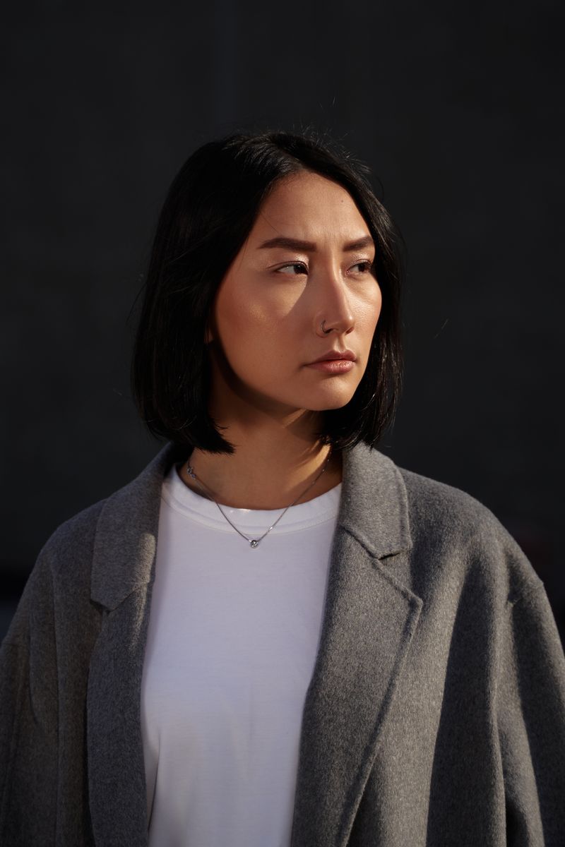 Model in a gray wool coat against a neutral backdrop