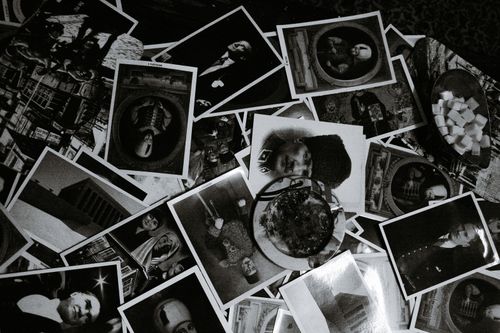 Free Top view black and white of assorted photos on desk with glass bowl at home Stock Photo