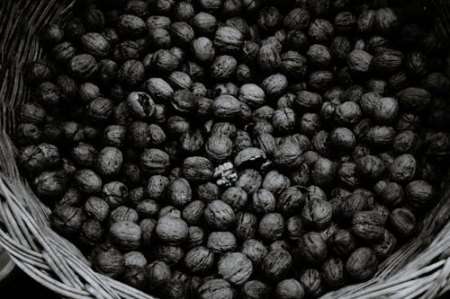 Pile of whole walnuts in wicker basket