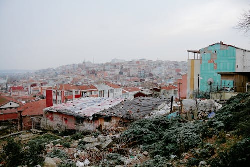 Old building facades on mountain under cloudy sky