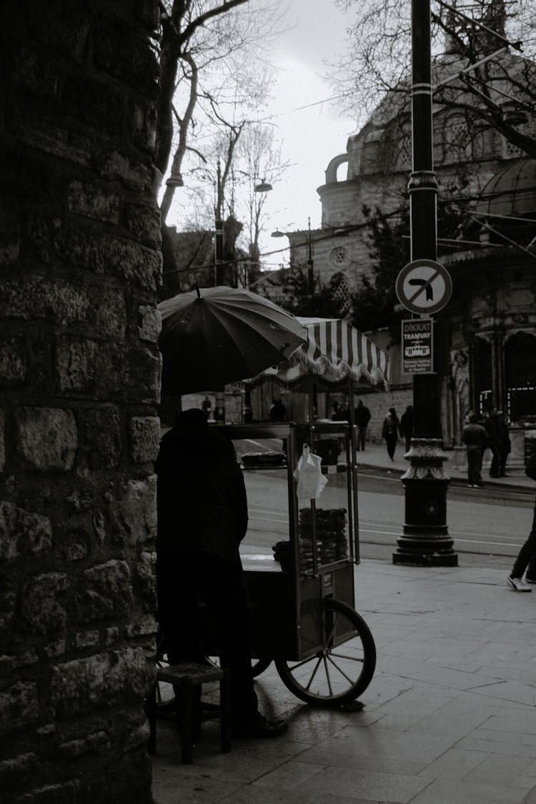 Unrecognizable Male Vendor Near Food Cart On Street