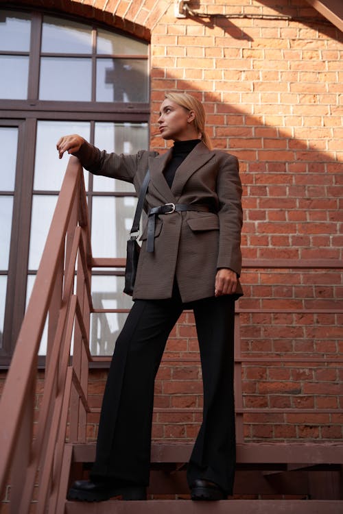 Woman in Blazer Leaning on a Railing