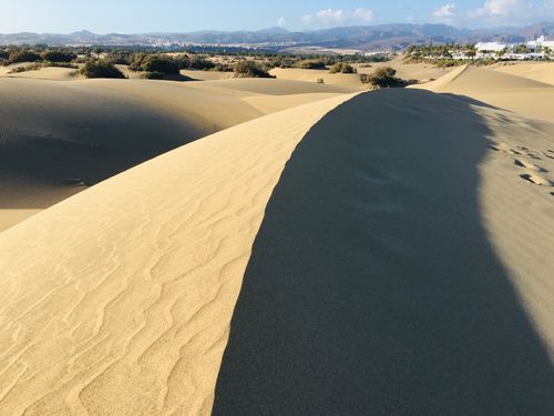 Free Stunning view of the Maspalomas sand dunes in Gran Canaria under a clear blue sky. Stock Photo