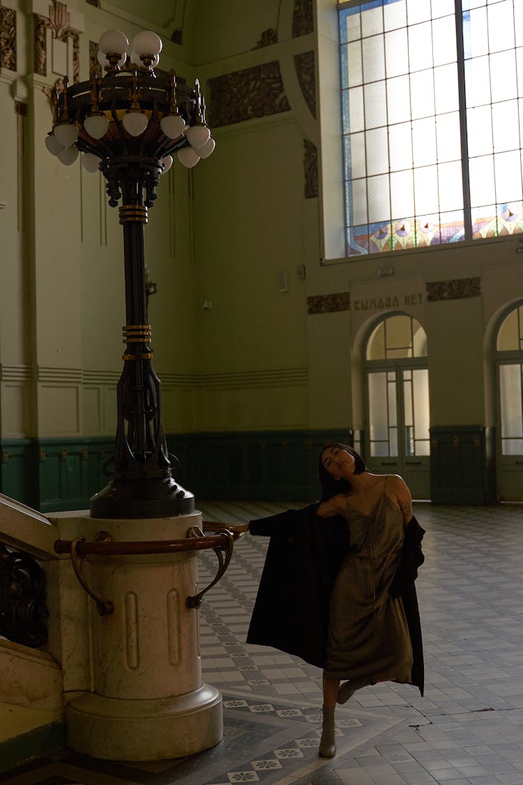 A Woman Holding On Metal Railing