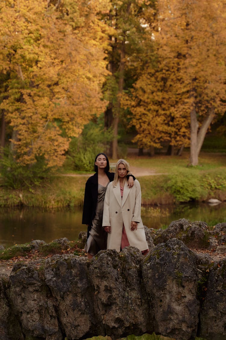 Women In Trench Coats Standing Together 