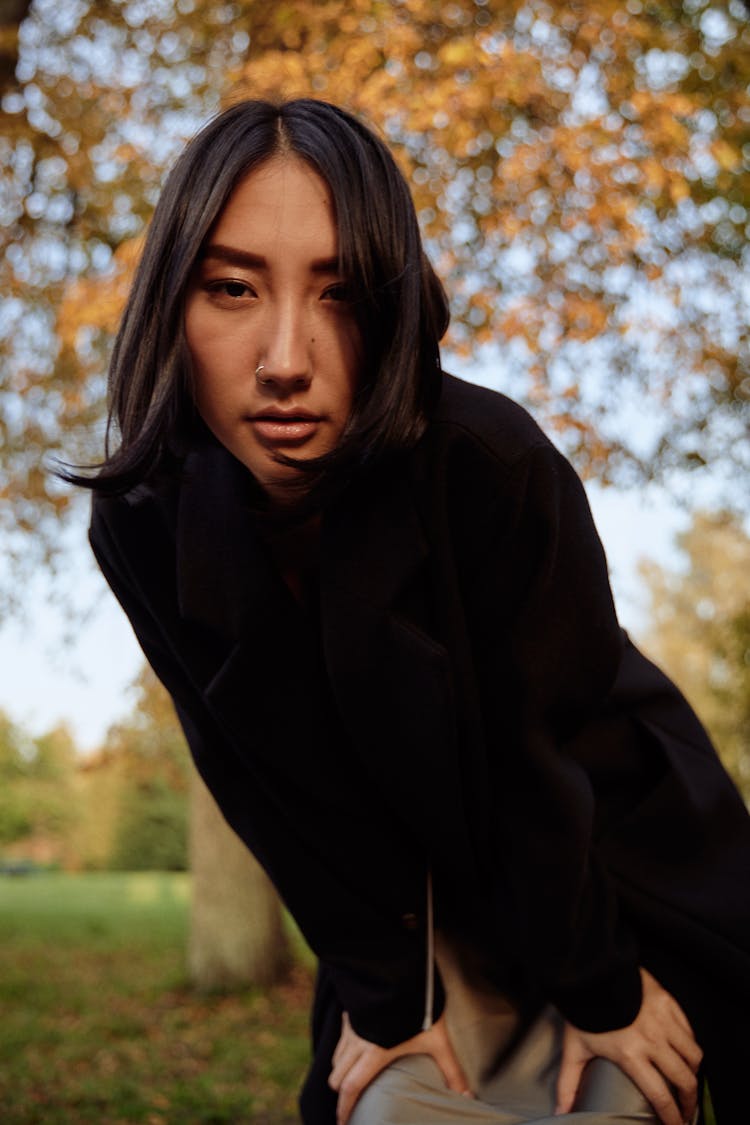 Woman Leaning Forward In Black Coat