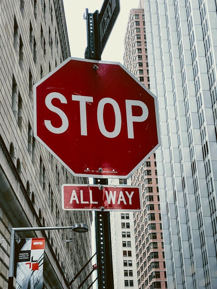 Stop Sign Against Building Exterior In New York City, USA