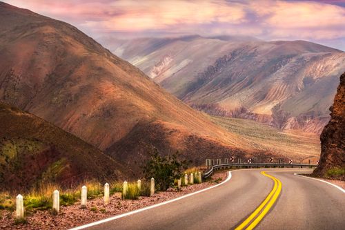 Free Curved road through colorful mountain landscape, perfect for adventure travel. Stock Photo