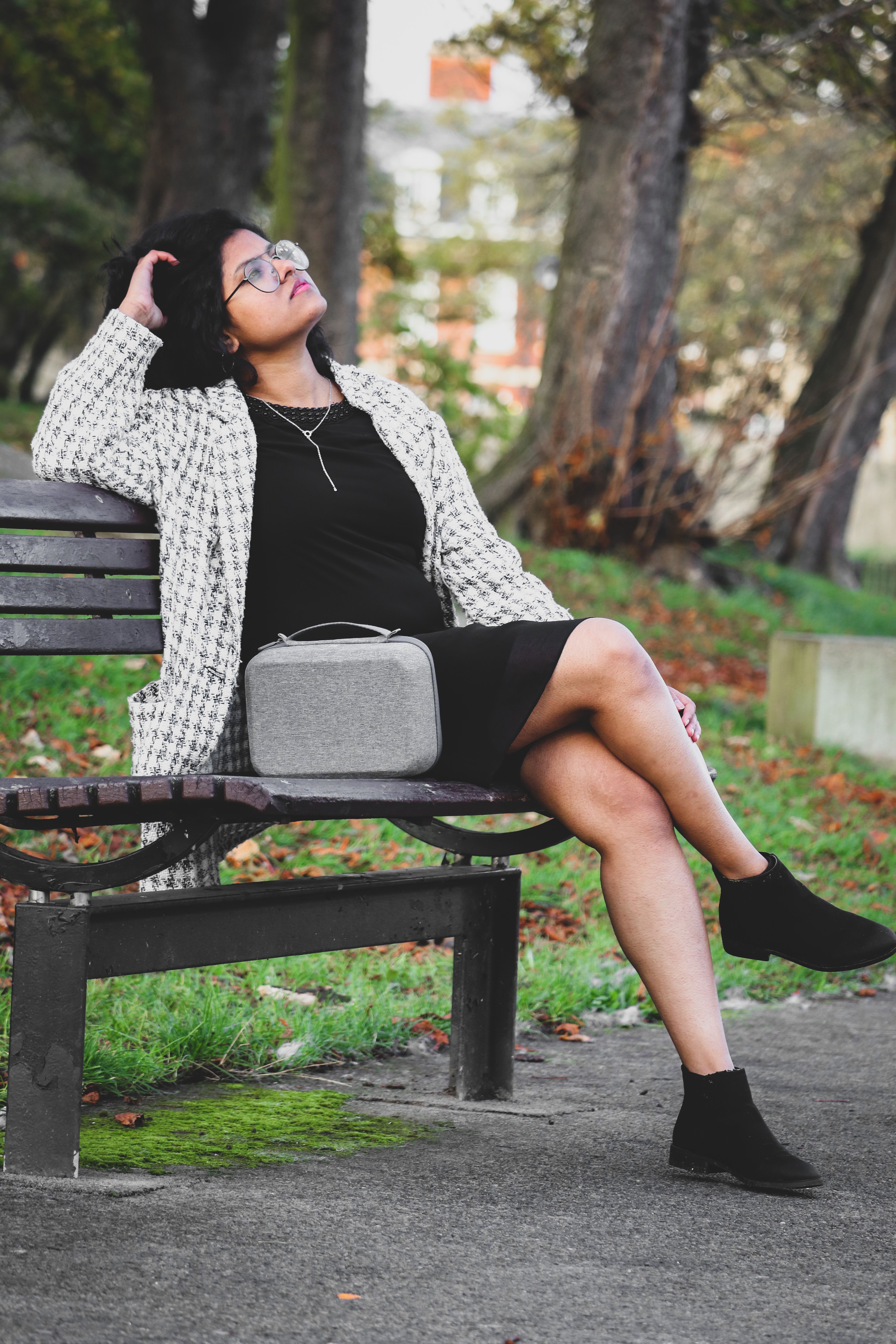 Woman Sitting on Bench in Park · Free Stock Photo