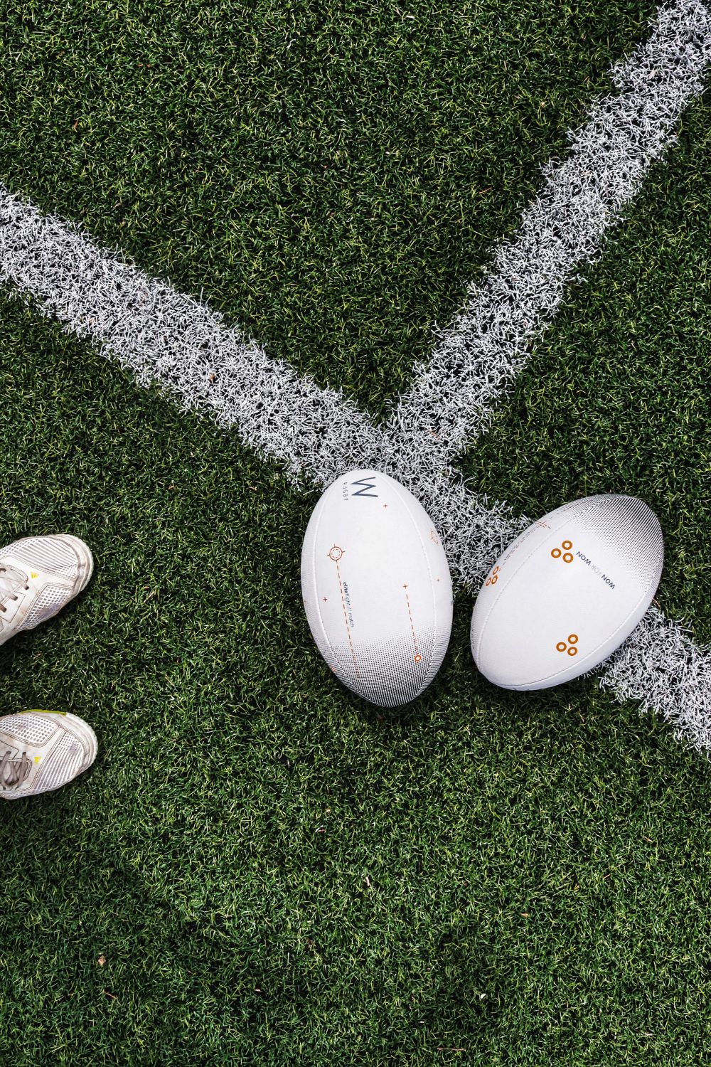 Match ball resting on wet grass before kickoff