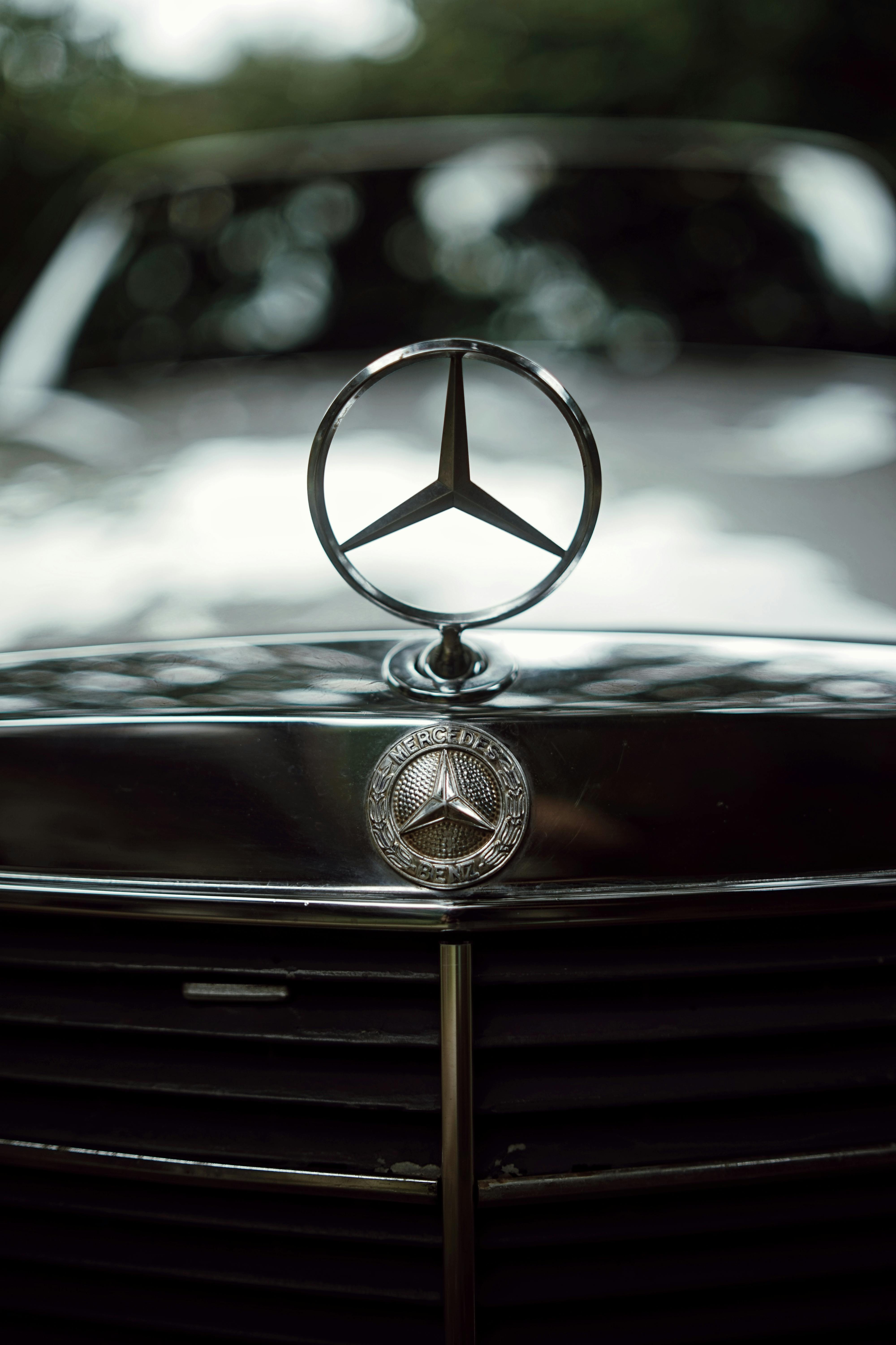 A Silver Emblem of a Mercedes Benz Car · Free Stock Photo