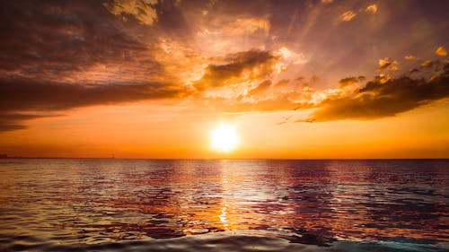 Free Beautiful Sunset Above Sea with Calm Waves Stock Photo