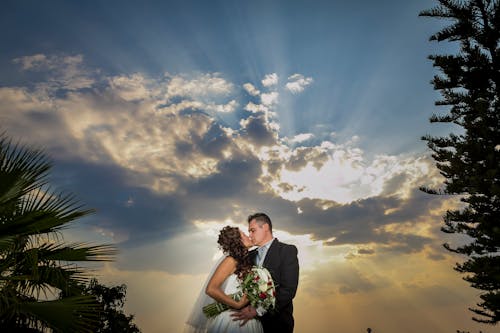 Free Couple Kissing Under Blue Sky Stock Photo