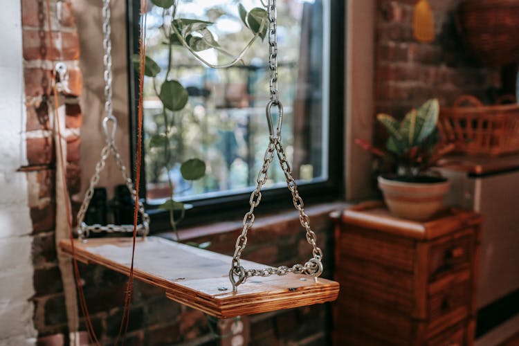 Swing With Metal Chains In Loft Style House Interior