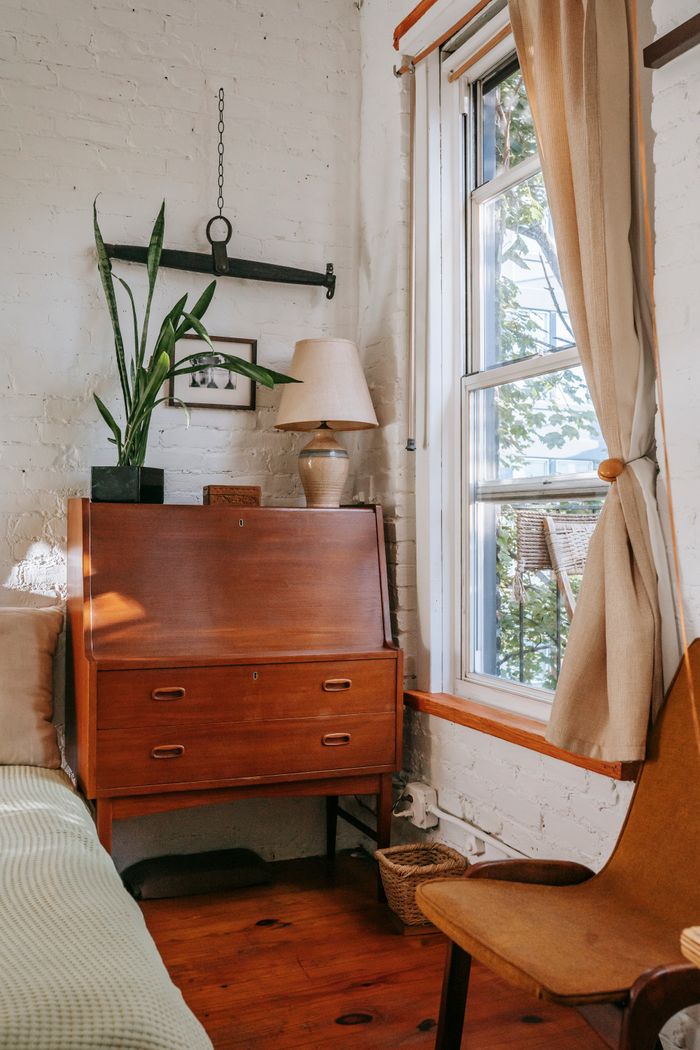 Placed photo: sunlit bedroom corner with a wooden bureau and linen curtain, photo by Charlotte May on Pexels