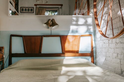 Cozy bed in light brick bedroom