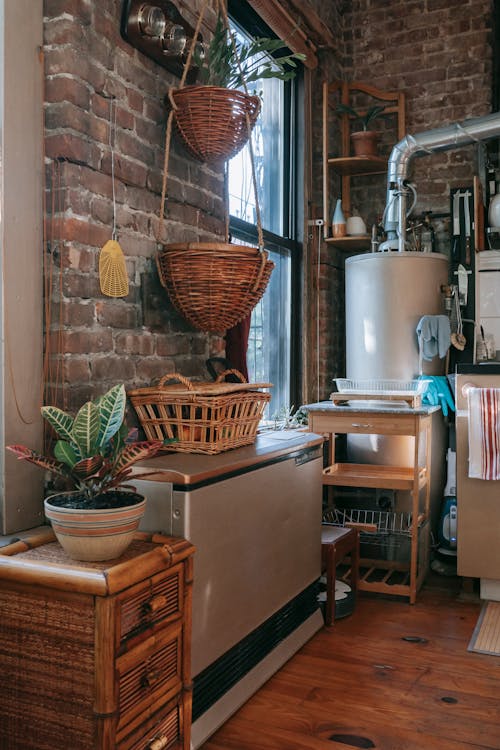Free Interior of kitchen with brick wall decorated with wicker baskets Stock Photo
