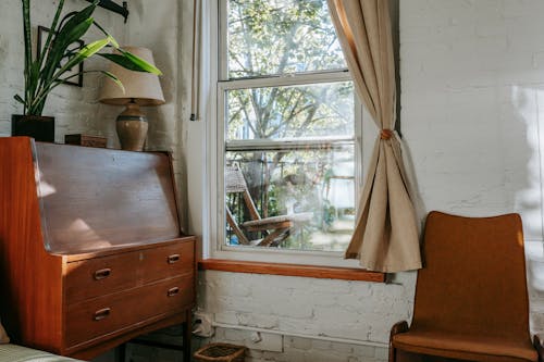 Room corner with vintage commode near window