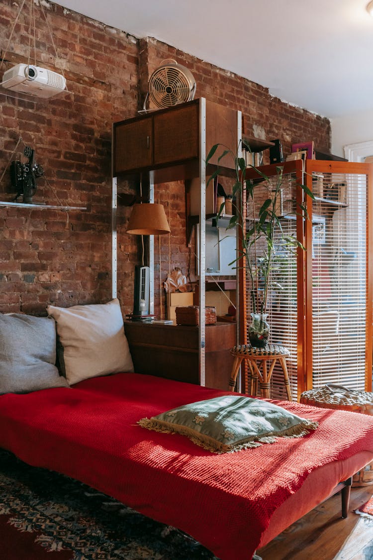 Stylish Bedroom Interior With Stone Wall And Flowerpots