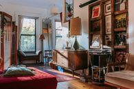 Interior of cozy studio with bed and couch decorated with vintage furniture and vinyl records