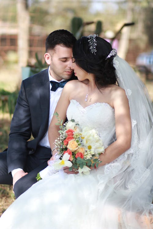 Bride and Groom Sitting with Eyes Closed 
