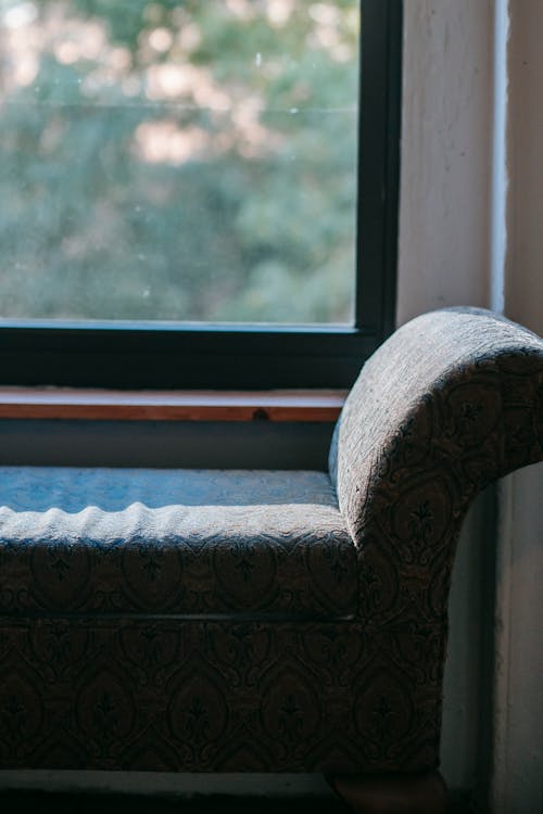 Old soft chair placed near window