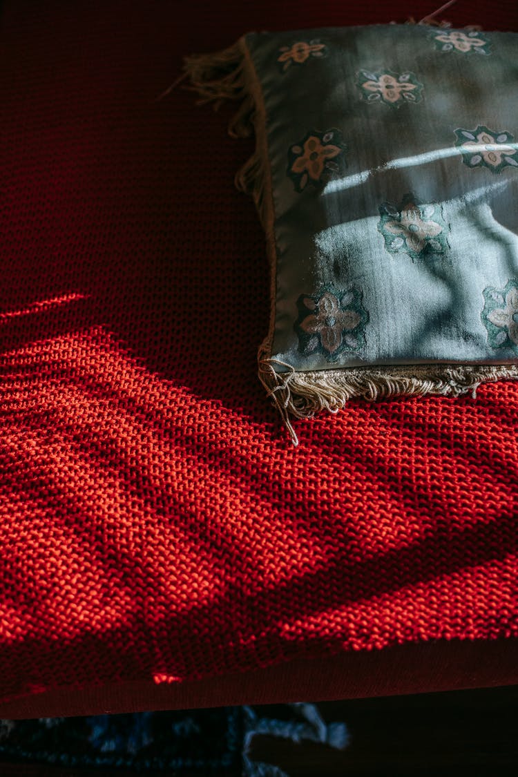 Bed With Red Bedspread And Pillow