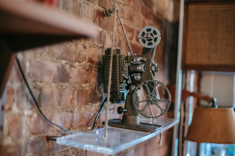 Vintage Film Projector Placed On Shelf In Room