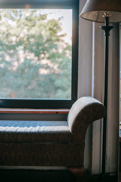 Aoft chair placed near large window · Free Stock Photo