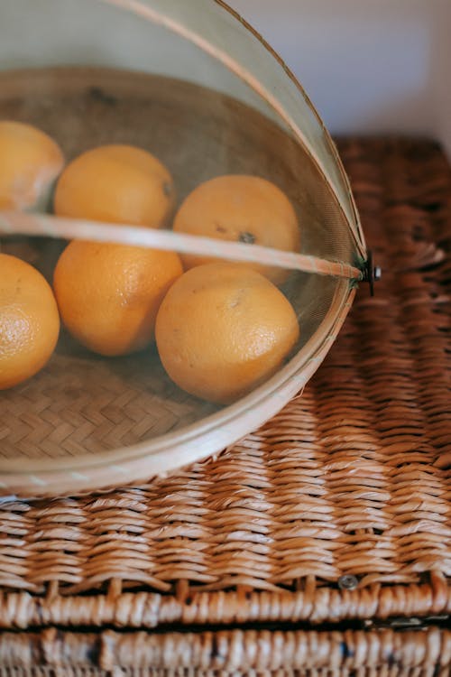 Free Tasty tangerines placed on wicker table Stock Photo