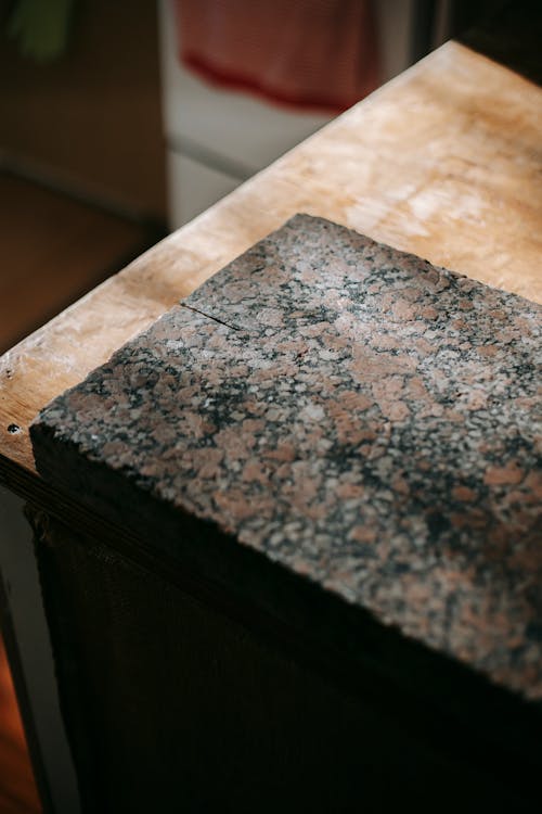 Brown granite board on wooden surface in sunlight