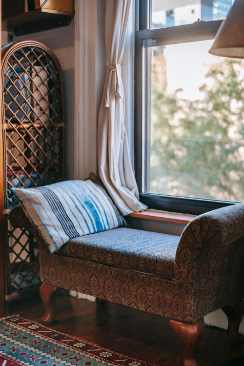 Free Interior of cozy living room with retro furniture and carpet near glass window Stock Photo