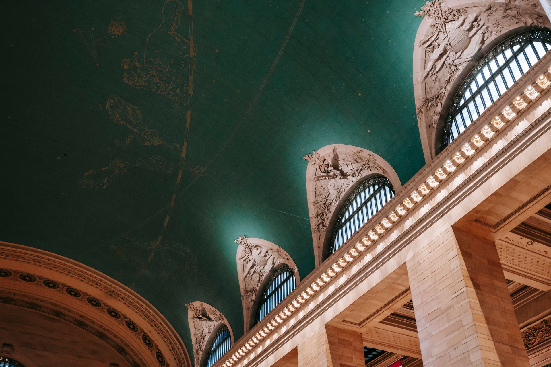 From below of interior of ornamental windows under ceiling with classic design and brick columns
