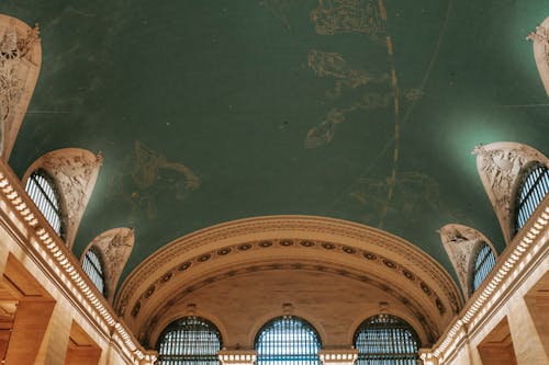 From below of interior of ornamental arched passage with classic columns and ceiling