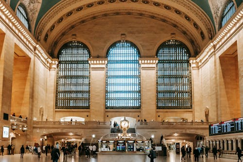 Interior of old Grand Central Terminal building with arched windows and ornamental ceiling over classic balconies