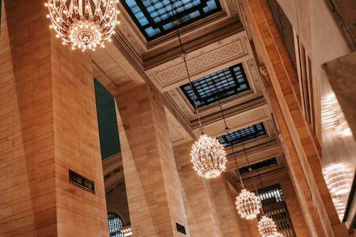 Free From below of classic interior of Grand Central Terminal with majestic chandeliers under ornamental ceiling with lattice over windows Stock Photo