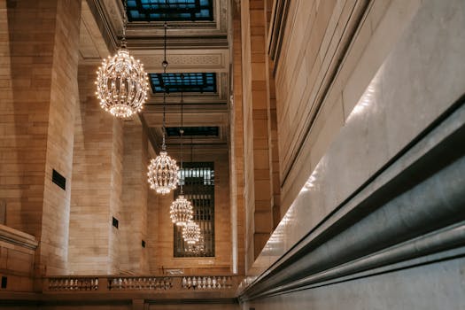 Elegant chandeliers illuminate the historic Grand Central Terminal's classic architecture.