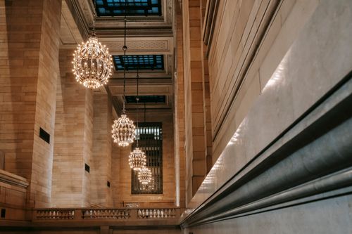 Free Classic interior of Grand Central Terminal with majestic chandeliers on ornamental ceiling with glass windows under lattice Stock Photo