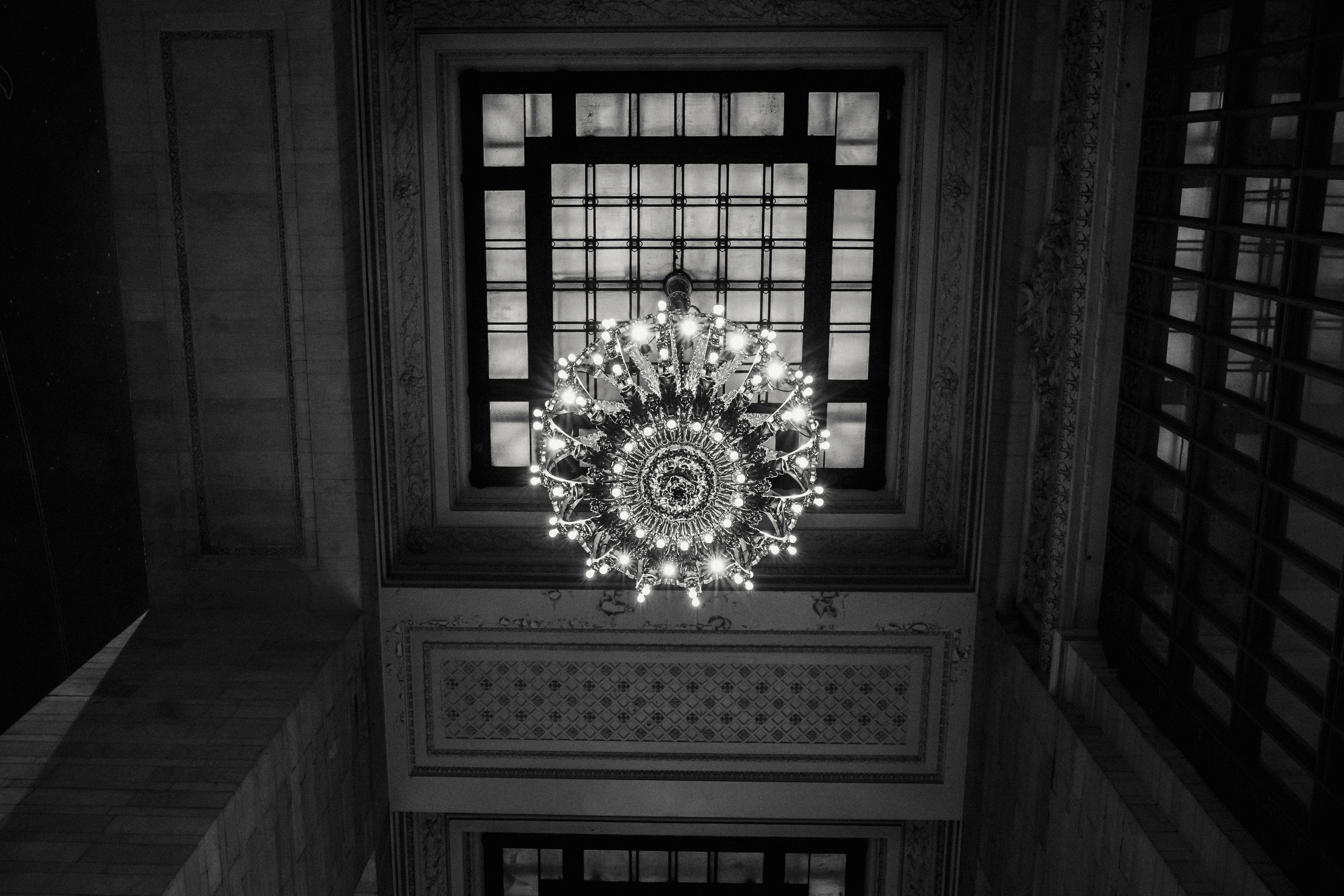 classic ceiling with chandelier and window