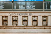 Interior of old box office with golden details under schedule in Grand Central Terminal