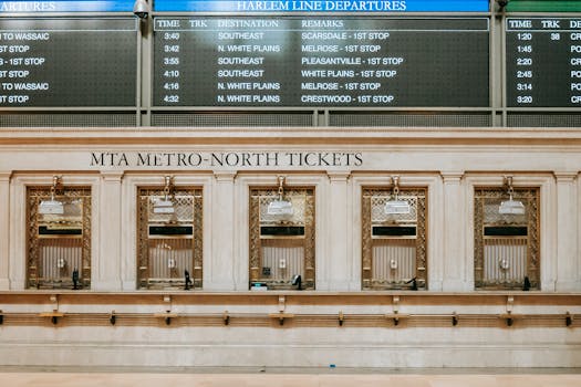 Interior of old box office with golden details under schedule in Grand Central Terminal
