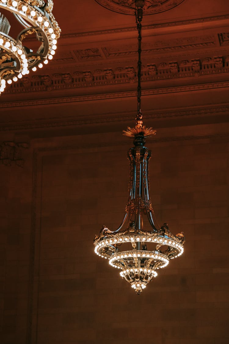 Classic Chandelier On Ornamental Ceiling In Museum