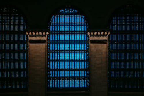 Free Building exterior with high blue windows with bars Stock Photo