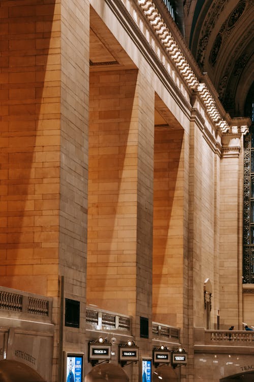 Shadow on wide brick columns located in spacious hall