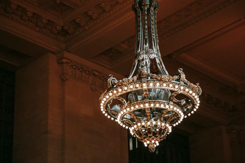 Free From below of classic chandelier with bright shiny lamps in old public structure Stock Photo