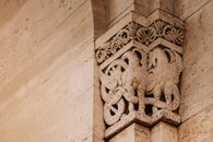 Interior of famous building with stone pilaster decorated with griffin