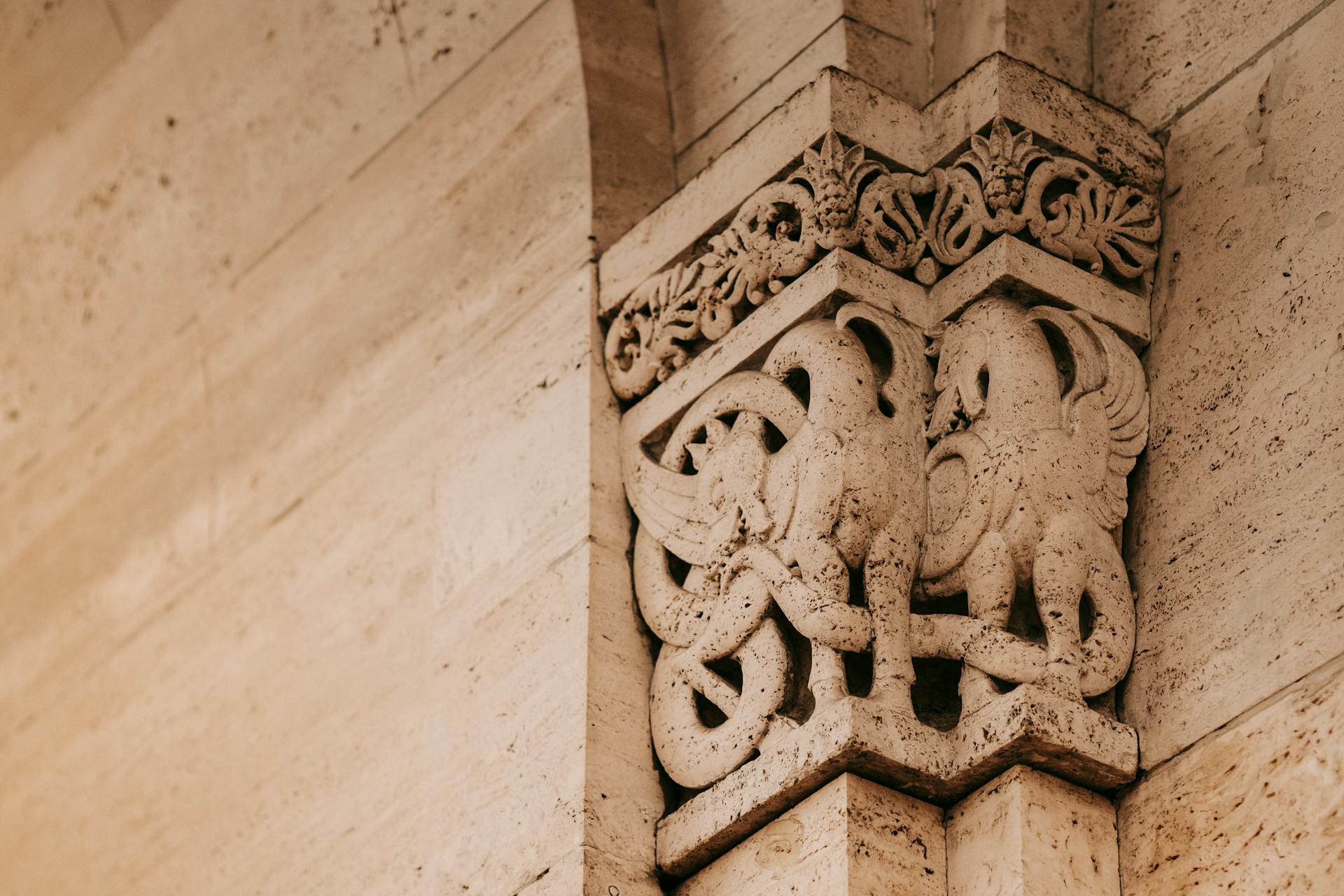 Interior of famous building with stone pilaster decorated with griffin