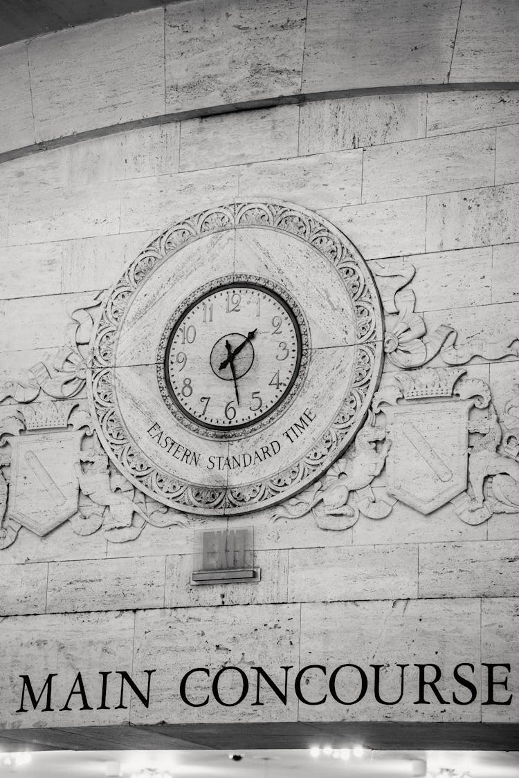 Engraving Of Emblem With Clock On Stone Wall